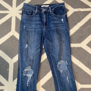 Blue denim size 28 Levi’s with rips in knees